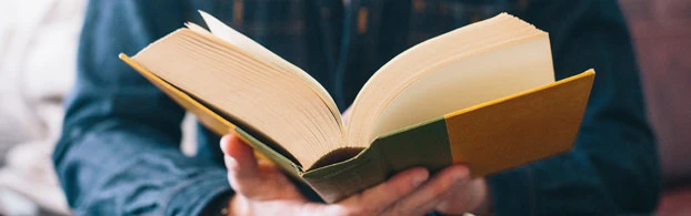 man reading an open book